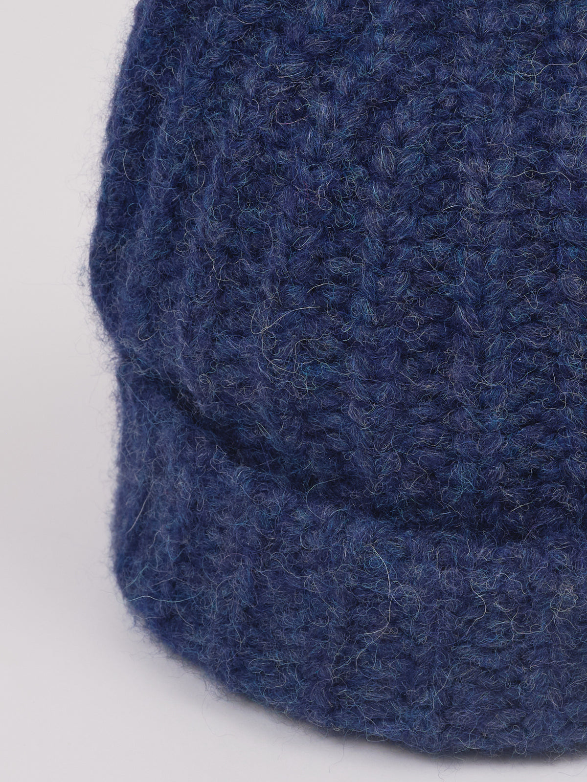 Baby-Alpaka-Mütze in Jeansblau von Manuela Bedford – Nahaufnahme der Strickstruktur und des umgeschlagenen Bündchens.