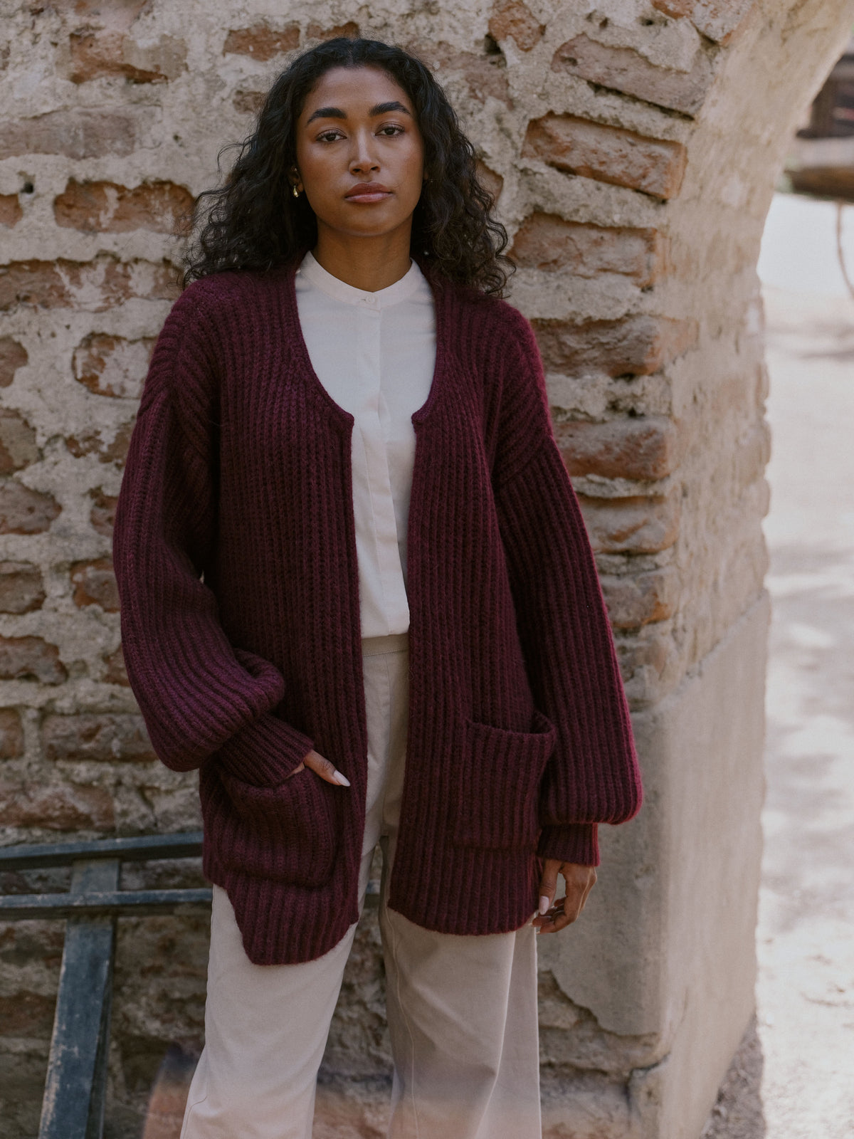 Nahaufnahme der Strickjacke Tinki aus Baby Alpaka in Berry von Manuela Bedford.